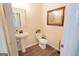 Powder room features a pedestal sink, toilet, and framed artwork on the wall at 337 Paynes Lake Rd, Carrollton, GA 30116