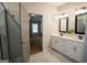 Bathroom featuring a double sink vanity, marble floors, and an open doorway to the main bedroom at 337 Paynes Lake Rd, Carrollton, GA 30116