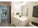 Bright bathroom featuring a white vanity with modern fixtures and a large mirror at 337 Paynes Lake Rd, Carrollton, GA 30116