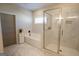 Bathroom featuring a glass-enclosed shower, soaking tub, and marble tiling at 337 Paynes Lake Rd, Carrollton, GA 30116