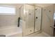 Bathroom features a glass-enclosed shower, soaking tub, and marble tiling at 337 Paynes Lake Rd, Carrollton, GA 30116