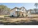 Two-story home with a covered front porch, dark shutters, and surrounded by a lush wooded landscape at 337 Paynes Lake Rd, Carrollton, GA 30116