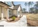 Elegant home with a manicured lawn and a paved walkway leading to the front door at 337 Paynes Lake Rd, Carrollton, GA 30116