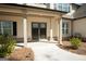 Inviting front porch with a double door entry, decorative columns, and manicured landscaping at 337 Paynes Lake Rd, Carrollton, GA 30116