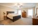 Spacious main bedroom with plush carpet, a ceiling fan, and a tray ceiling at 337 Paynes Lake Rd, Carrollton, GA 30116