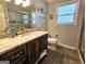 Modern bathroom with a marble countertop vanity, stylish mirror, and updated fixtures at 170 Royal Ridge Way, Fayetteville, GA 30215