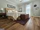 Cozy bedroom featuring a plush bed, soft lighting, and wood-look floors at 170 Royal Ridge Way, Fayetteville, GA 30215