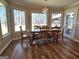 Bright dining room with wood floors, large windows, and a stylish light fixture at 170 Royal Ridge Way, Fayetteville, GA 30215