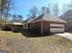 Side view showing an attached garage, brick veneer, manicured lawn, and a paved driveway at 170 Royal Ridge Way, Fayetteville, GA 30215