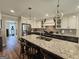 Spacious kitchen featuring a large island with granite countertops and modern appliances at 170 Royal Ridge Way, Fayetteville, GA 30215