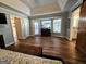 A spacious main bedroom is enhanced by wood floors, a ceiling fan, and a private bathroom with a barn door at 170 Royal Ridge Way, Fayetteville, GA 30215