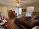 Comfortable bedroom featuring a ceiling fan, wood flooring, and natural light from the windows at 418 Kenny Ln, Temple, GA 30179