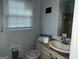 Bathroom featuring white fixtures and large window, with gray and white walls at 676 Bralorne Dr, Stone Mountain, GA 30087