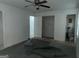 Bedroom with incomplete flooring, ceiling fan, and an en-suite bathroom entrance visible from the doorway at 676 Bralorne Dr, Stone Mountain, GA 30087