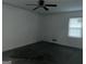 Bedroom featuring incomplete flooring, a ceiling fan, and a window that provides natural light at 676 Bralorne Dr, Stone Mountain, GA 30087