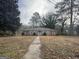 Charming brick home featuring a well-maintained lawn and mature trees at 676 Bralorne Dr, Stone Mountain, GA 30087