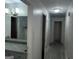 Hallway with multiple doors with lighting, leading to bathroom with gray countertops at 676 Bralorne Dr, Stone Mountain, GA 30087