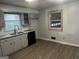 Kitchen area with modern gray cabinetry and hardwood floors offering opportunity for customization at 676 Bralorne Dr, Stone Mountain, GA 30087