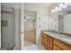 Bathroom featuring granite countertop vanity, shower and entrance to bedroom at 2768 Southpark Sw Blvd, Conyers, GA 30094