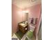 Cozy bathroom with granite vanity, pink walls, toilet, and green rug at 2768 Southpark Sw Blvd, Conyers, GA 30094