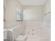 Bright bathroom features a large soaking tub with tile surround and natural light at 2768 Southpark Sw Blvd, Conyers, GA 30094