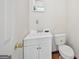 Bathroom featuring white vanity, toilet and mirror at 2768 Southpark Sw Blvd, Conyers, GA 30094