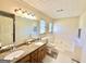 Large bathroom with a double vanity, jacuzzi tub, and neutral finishes at 2768 Southpark Sw Blvd, Conyers, GA 30094