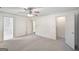 Large bedroom with carpeting, ceiling fan and access to additional rooms and bathroom at 2768 Southpark Sw Blvd, Conyers, GA 30094