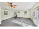 Spacious bonus room features a ceiling fan, large windows, and gym equipment at 2768 Southpark Sw Blvd, Conyers, GA 30094