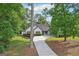 Lovely home with a spacious driveway, green lawn, and mature trees surrounding the property at 2768 Southpark Sw Blvd, Conyers, GA 30094
