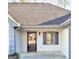 Close up of front entrance featuring a newer door and classic decorative shuttered window at 2768 Southpark Sw Blvd, Conyers, GA 30094