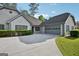 Charming home with a manicured lawn, gray trim, a driveway, and an attached garage at 2768 Southpark Sw Blvd, Conyers, GA 30094