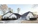 Charming home with a manicured lawn, gray trim, a driveway, and an attached garage at 2768 Southpark Sw Blvd, Conyers, GA 30094