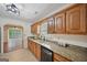Classic kitchen featuring wooden cabinets, granite countertops, and stainless steel sink at 2768 Southpark Sw Blvd, Conyers, GA 30094