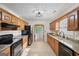Kitchen featuring wooden cabinets, granite countertops, and black appliances at 2768 Southpark Sw Blvd, Conyers, GA 30094
