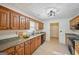 Bright kitchen featuring wooden cabinets, granite countertops, and stainless steel sink at 2768 Southpark Sw Blvd, Conyers, GA 30094