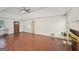 Bright living room features a brick fireplace, wood-look flooring, and a vaulted ceiling at 2768 Southpark Sw Blvd, Conyers, GA 30094