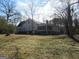 Rear view of home, screened porch, and spacious wooded lot at 526 Mount Carmel Church Rd, Temple, GA 30179