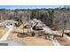 Aerial view showcasing the home's location, landscaping, driveway, and proximity to mature trees at 6 Water Oak Dr, Sharpsburg, GA 30277