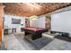 Finished basement with a pool table, open ceiling, and bar stools creating an entertainment space at 6 Water Oak Dr, Sharpsburg, GA 30277