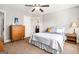 Cozy bedroom with carpet, neutral walls, ceiling fan and a door to the bathroom at 6 Water Oak Dr, Sharpsburg, GA 30277