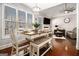 Bright dining area featuring a large table with seating and a view of the backyard at 6 Water Oak Dr, Sharpsburg, GA 30277