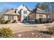 Beautiful two-story home features a manicured lawn, stone accents, a red front door, and lovely landscaping at 6 Water Oak Dr, Sharpsburg, GA 30277
