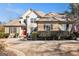 Inviting two-story home boasts a well-kept lawn, stone detailing, a vibrant red front door, and neat landscaping at 6 Water Oak Dr, Sharpsburg, GA 30277