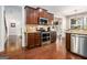 Modern kitchen boasts stainless steel appliances, wood cabinetry, and a view into the dining area at 6 Water Oak Dr, Sharpsburg, GA 30277
