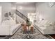 Bright living room with vaulted ceiling, staircase, neutral furniture, and decor at 6 Water Oak Dr, Sharpsburg, GA 30277