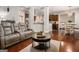Open-concept living room with hardwood floors and a seamless flow into the kitchen and dining areas at 6 Water Oak Dr, Sharpsburg, GA 30277