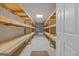 Basement storage room with built-in wooden shelving units at 225 Chinns Way, Hampton, GA 30228