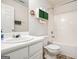 Bright bathroom with a white sink, toilet and shower-tub combination at 225 Chinns Way, Hampton, GA 30228