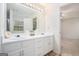 Bathroom featuring double sink vanity with a large mirror at 225 Chinns Way, Hampton, GA 30228
